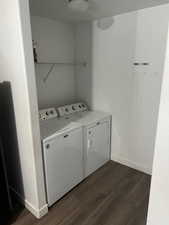 Washroom featuring dark hardwood / wood-style floors and separate washer and dryer