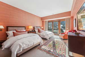 Carpeted bedroom featuring french doors and access to outside