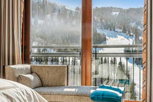 Snow covered back of property with a mountain view