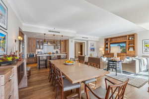 Dining area featuring dark wood-type flooring and sink