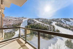 Snow covered back of property featuring a mountain view