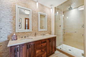 Bathroom featuring vanity and an enclosed shower