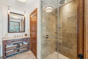 Bathroom with sink and a shower with door