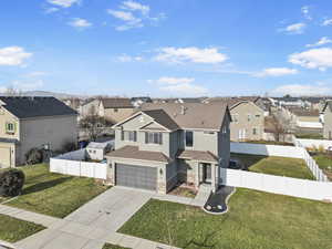 View of front of property with a front lawn and a garage