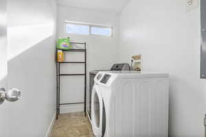 Clothes washing area featuring independent washer and dryer