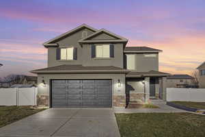 Front facade with a lawn and a garage