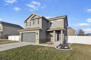 View of front of home featuring a garage and a front lawn