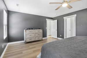 Bedroom with ceiling fan and light wood-type flooring