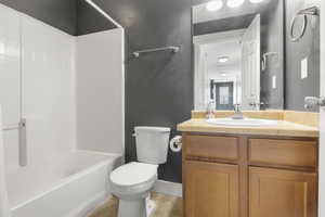 Full bathroom featuring vanity, toilet, and shower / washtub combination