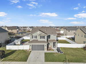 View of front facade with a garage and a front lawn