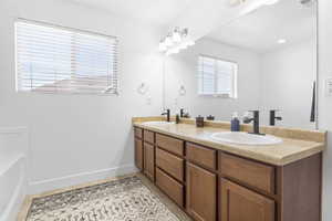 Bathroom featuring tile patterned flooring and vanity