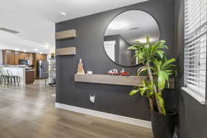 Interior space featuring stainless steel refrigerator with ice dispenser and hardwood / wood-style floors