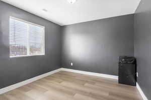 Unfurnished room with light wood-type flooring