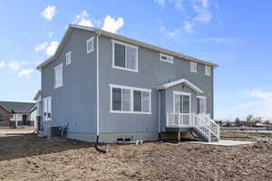 Back of house featuring central AC unit and crawl space