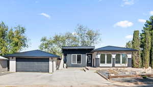 View of front of home with a porch and a garage