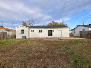 Back of property with a yard, a patio, and cooling unit