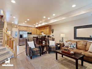 Living room featuring crown molding and light hardwood / wood-style floors