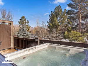 View of pool featuring a mountain view and a hot tub