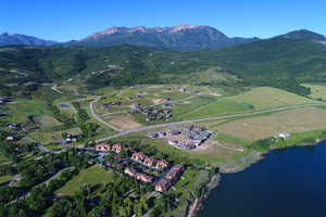 Birds eye view of property featuring a water and mountain view