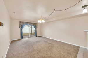 Spare room featuring an inviting chandelier