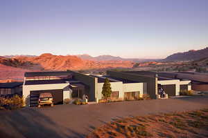 View of front of property with a mountain view and a garage