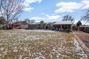 Snow covered house featuring a sunroom