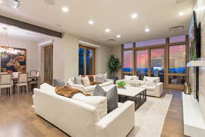 Living room with a chandelier and light hardwood / wood-style floors