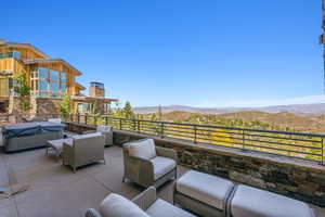 View of patio featuring a mountain view, a grill, a balcony, and an outdoor hangout area