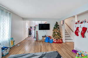 Rec room featuring a textured ceiling and hardwood / wood-style flooring