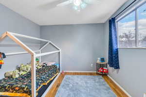 Bedroom featuring hardwood / wood-style floors and ceiling fan