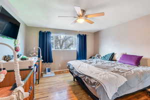 Bedroom featuring hardwood / wood-style flooring and ceiling fan