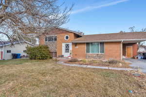 Split level home featuring a front yard