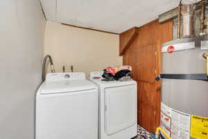 Laundry area featuring washer and dryer and water heater