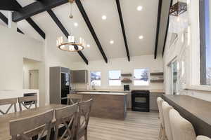 Kitchen featuring high vaulted ceiling, a notable chandelier, beam ceiling, and black range with electric cooktop