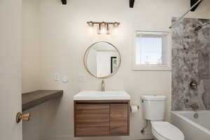 Full bathroom with vanity,  shower combination, and toilet