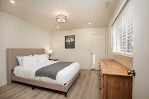 Bedroom with light hardwood / wood-style flooring