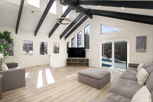 Living room with beam ceiling, light hardwood / wood-style flooring, and high vaulted ceiling