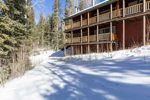 View of snow covered rear of property