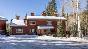 View of snow covered back of property