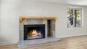 Interior details featuring a tile fireplace and wood-type flooring