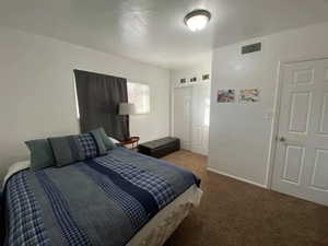 Bedroom featuring carpet and a closet