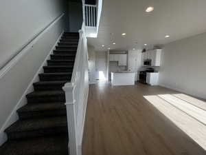 Staircase with hardwood / wood-style floors