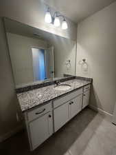 Bathroom with tile patterned floors and vanity