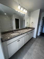 Bathroom with tile patterned floors and vanity