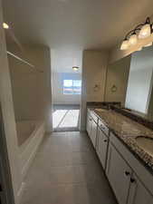 Bathroom featuring tile patterned flooring and vanity