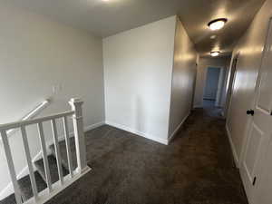 Hall with dark colored carpet