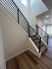 Staircase featuring hardwood / wood-style flooring and plenty of natural light