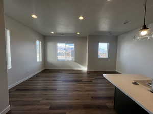 Unfurnished dining area featuring dark hardwood / wood-style floors