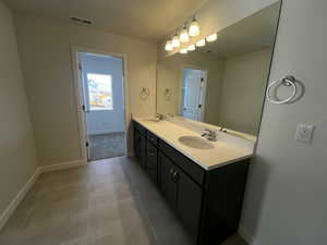 Bathroom with vanity and tile patterned floors