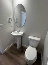 Bathroom featuring hardwood / wood-style floors and toilet